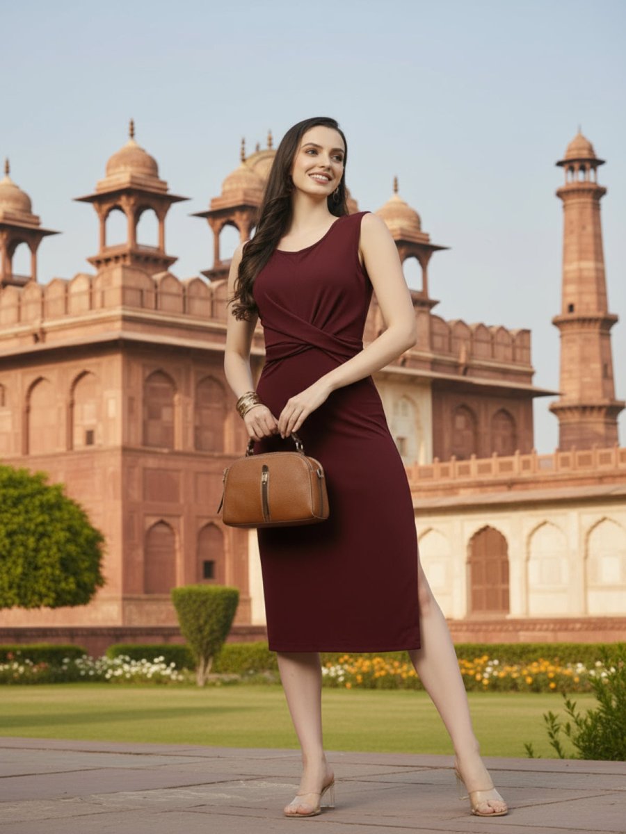 Woman in a burgundy dress holding a brown handbag against a brown background
