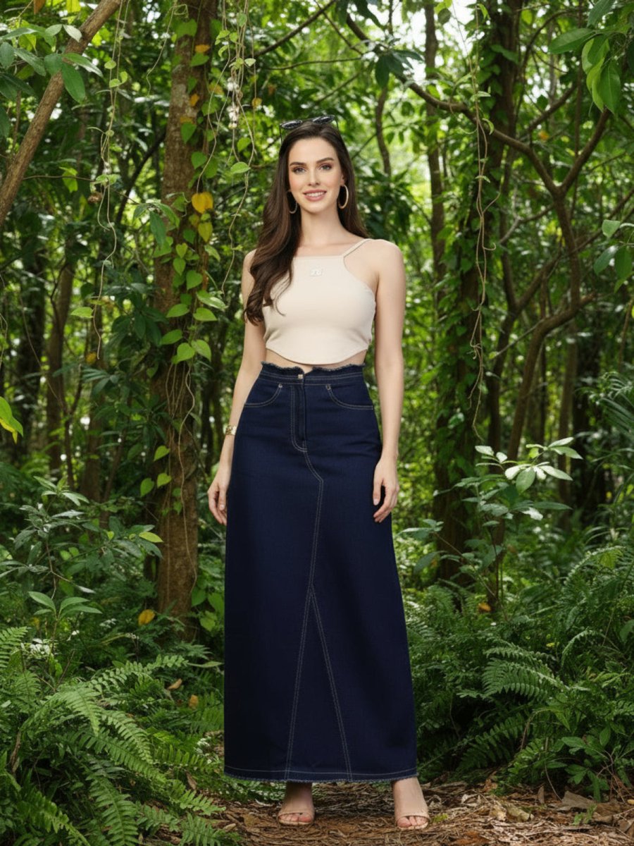 Woman in a beige top and dark blue pants standing in a forest